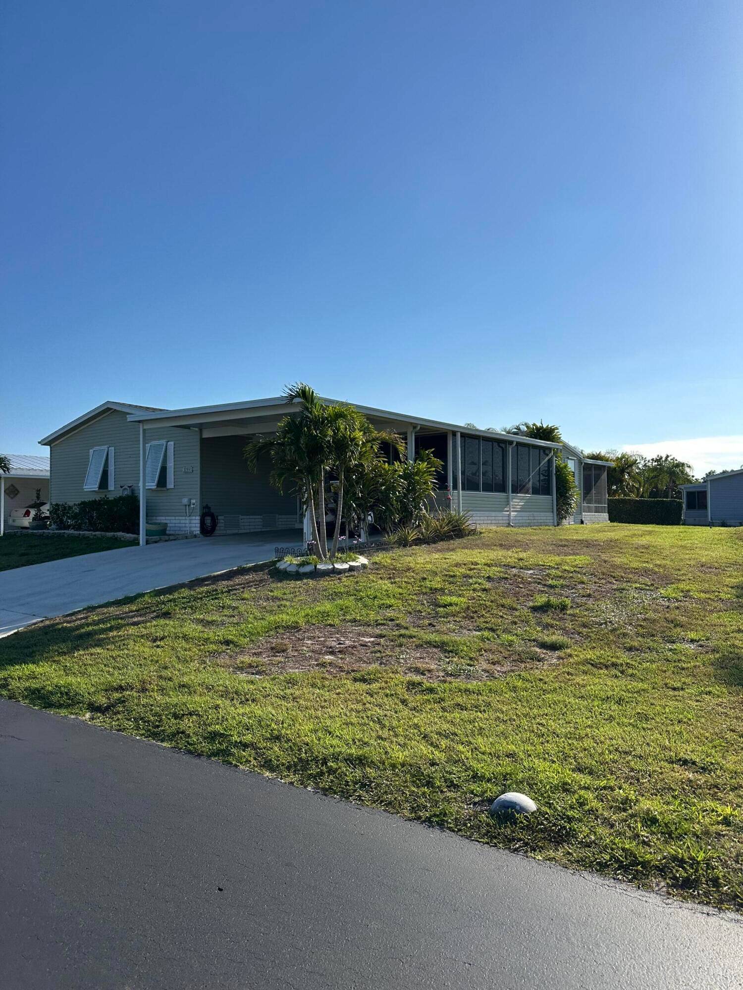 Welcome to this spacious and beautifully maintained 3 bedroom, 2 bath triple wide manufactured home, located in the vibrant 55 community of Tropical Isles in Fort Pierce, Florida.