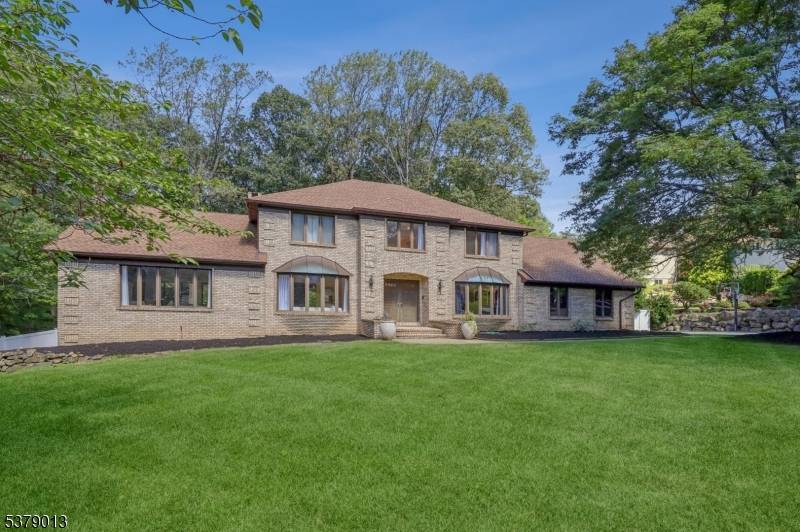 Nestled amidst nature in one of Parsippany's most desirable neighborhoods, this stunning residence offers over 4, 000 sq.