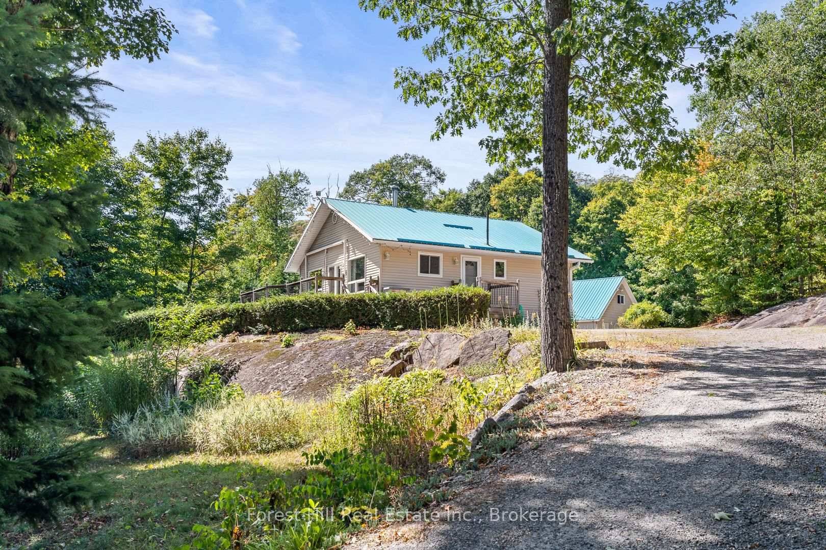 Idyllic rural setting for 4 season living on a year round road, located close to a sandy beach and boat launch area to Kawagama Lake and Herb Lake.