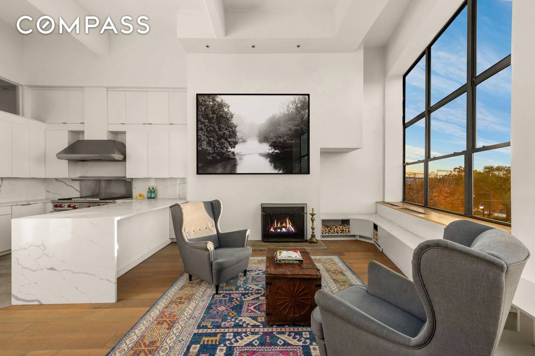 Rarely available duplex loft with 15 ft ceilings and massive windows showcasing spectacular Hudson River views in the heart of the West Village.