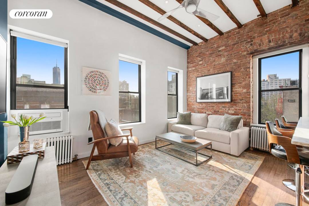 Welcome home to one of SoHo's most special offerings a sun drenched, top floor junior one bedroom carefully designed by an architect, effortlessly blending pre war charm with a stunning ...