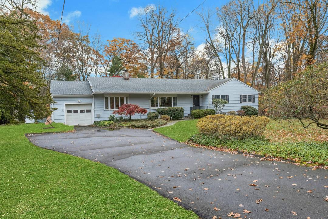 Nestled on a tranquil cul de sac, this extensively renovated home sits on a picturesque half acre lot with a park like setting.