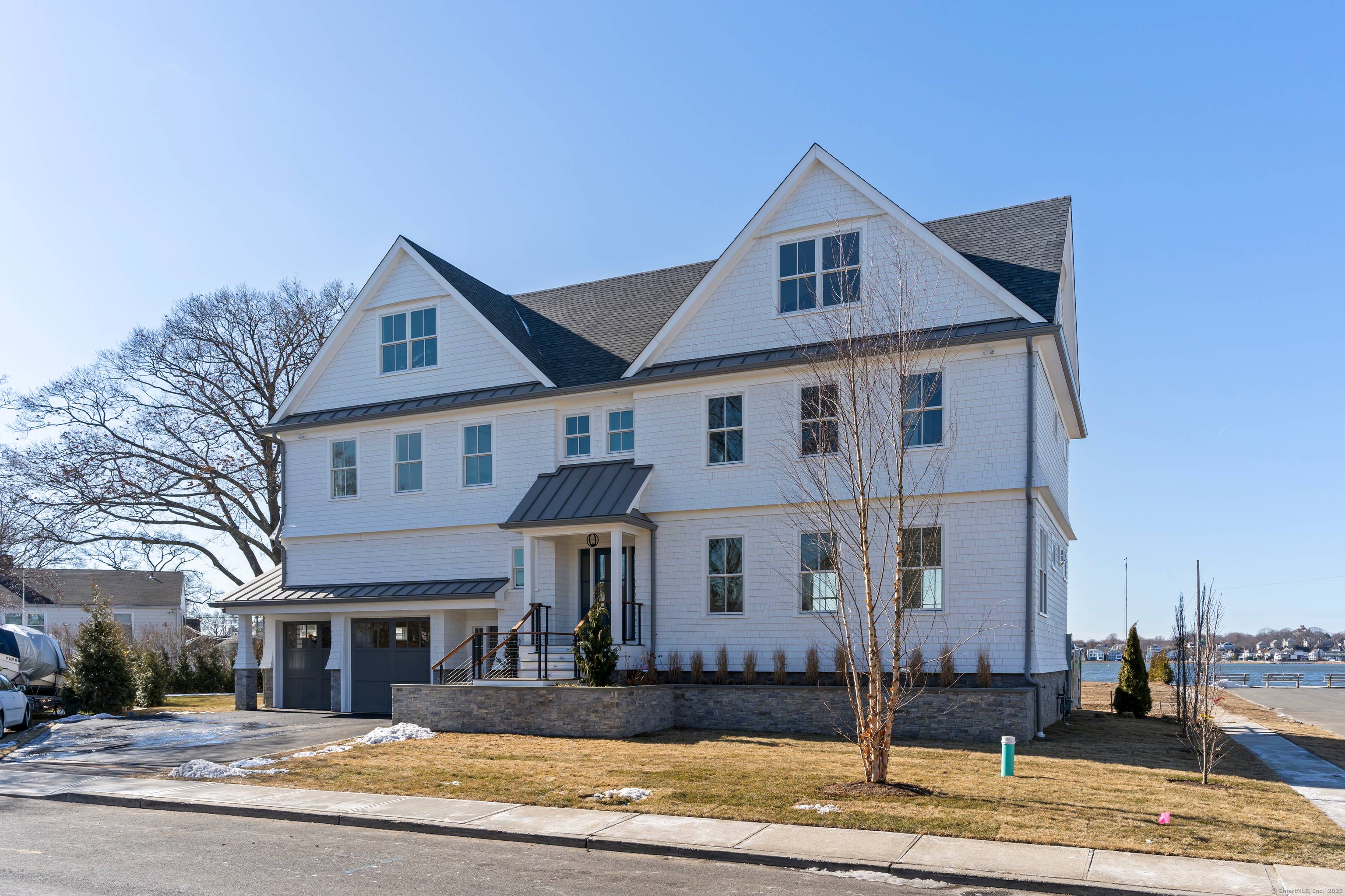 Enjoy rare and abundant protected water views in this luxury home featuring high end finishes, sunlit interiors, and outdoor access on all three levels.