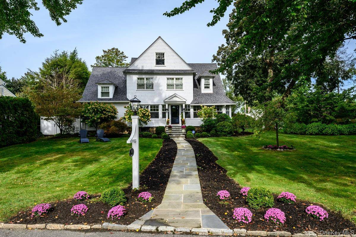 Welcome to 17 Deerfield Avenue, a stunning 1901 Farmhouse Colonial nestled in the heart of Bronxville Manor.