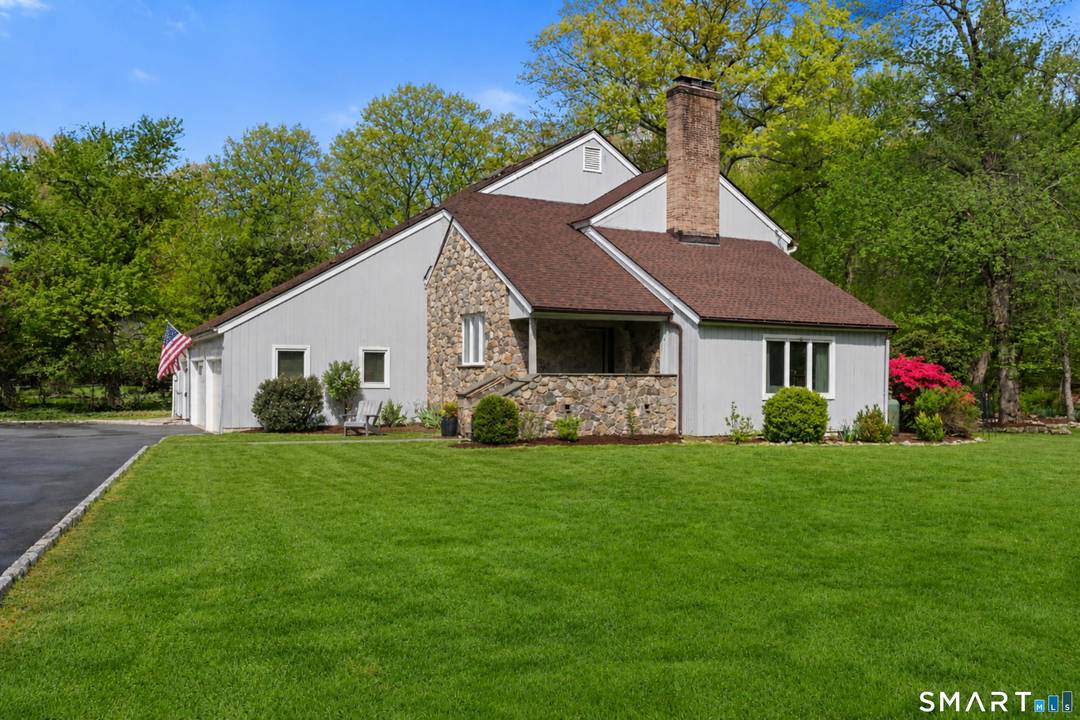 Set on a sunny acre well back from the street, this beautifully maintained and thoughtfully updated 4 bedroom, 2.