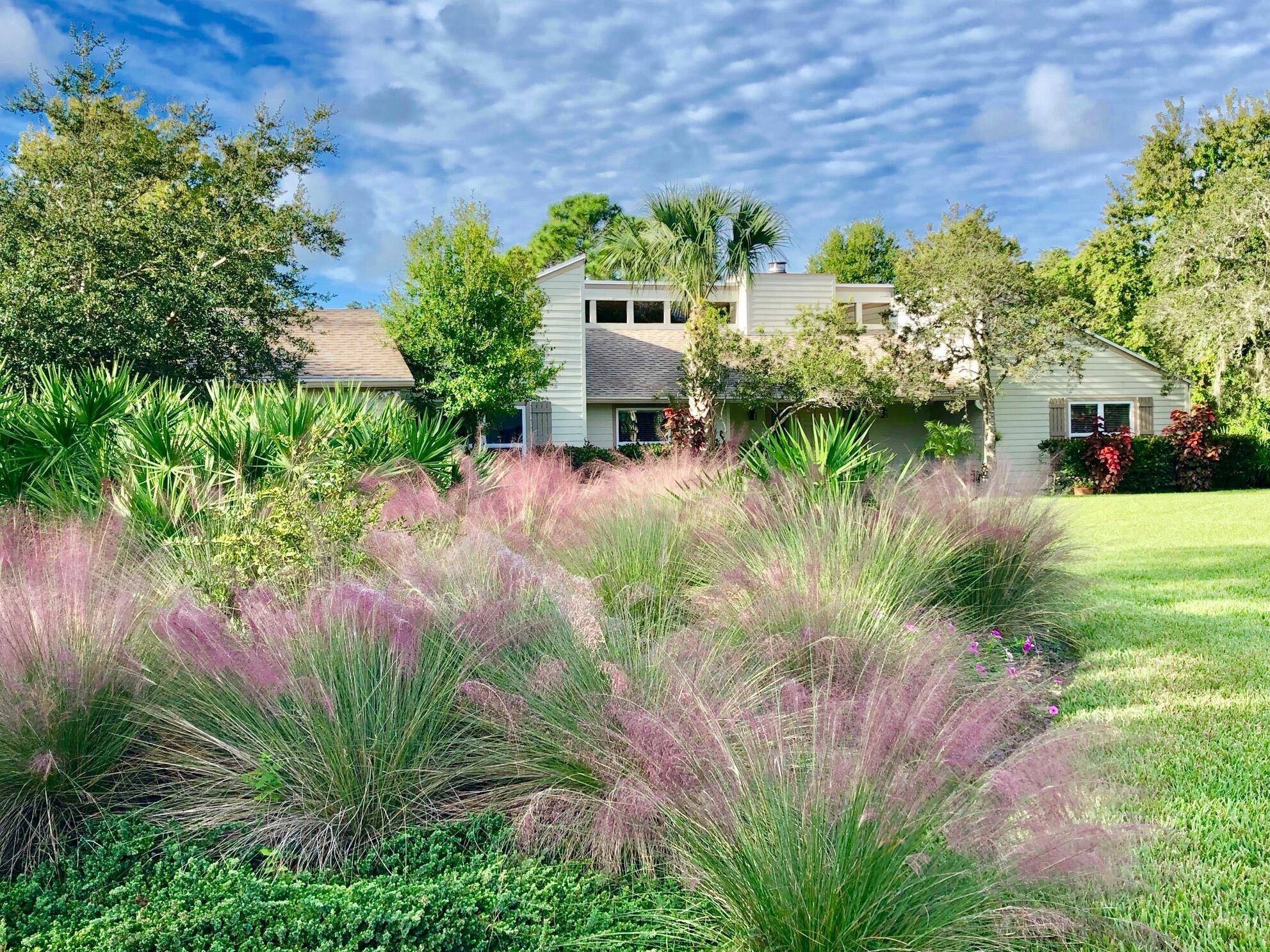 Welcome to this luxurious Crane Creek residence located within the gated Martin Downs Country Club community.