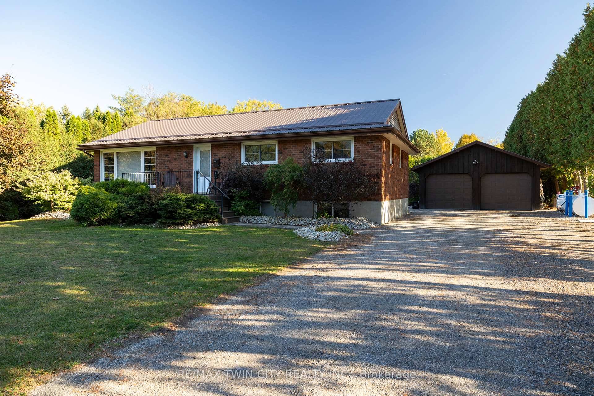 Absolutely stunning, all brick bungalow with a fully finished basement apartment and the amazing 23' x 30' detached amp ; heated workshop, on a half acre country lot.
