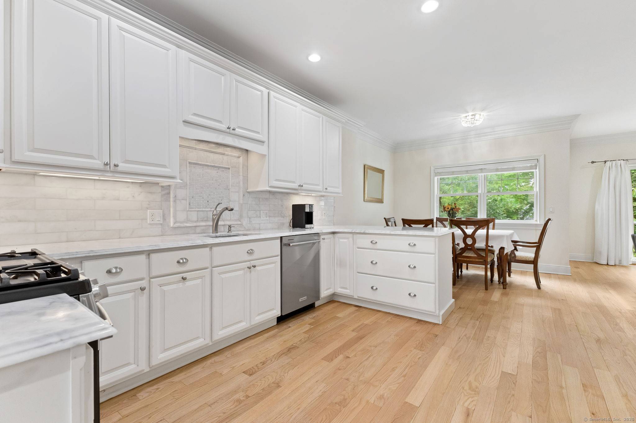 Welcome to The Maples, an exceptional townhome community nestled in a private, wooded enclave on the Darien border.