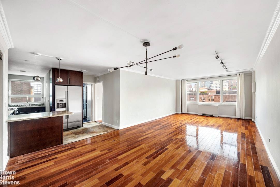 This light filled, oversized one bedroom, one bathroom home offers open northern and western exposures with wide city views in a full service building in the heart of Lenox Hill.