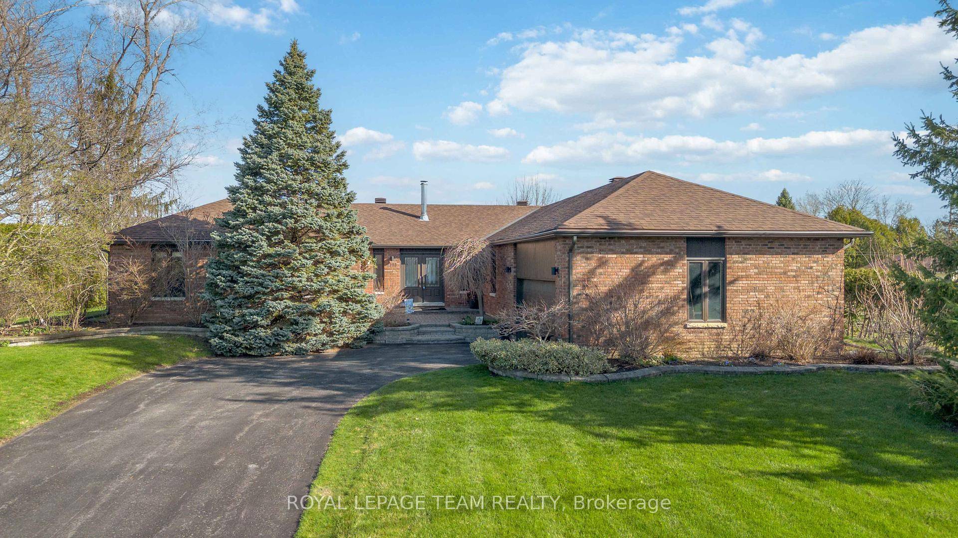 Presenting a meticulously maintained all brick bungalow with oversized double garage, situated on an expansive lot in the highly sought after community of Greely.