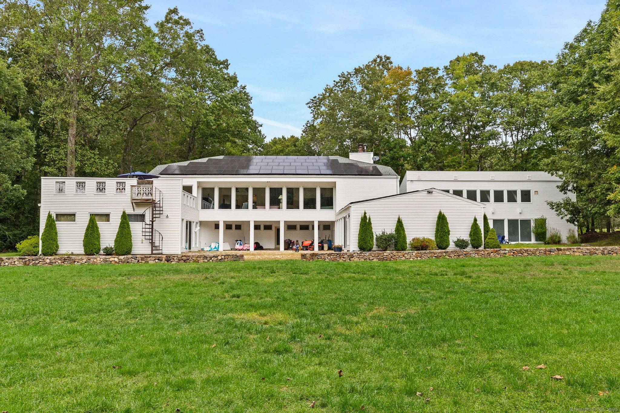 Tucked at the end of a private drive, 7 Hart Road in Guilford is an architectural gem wrapped in history and elegance.