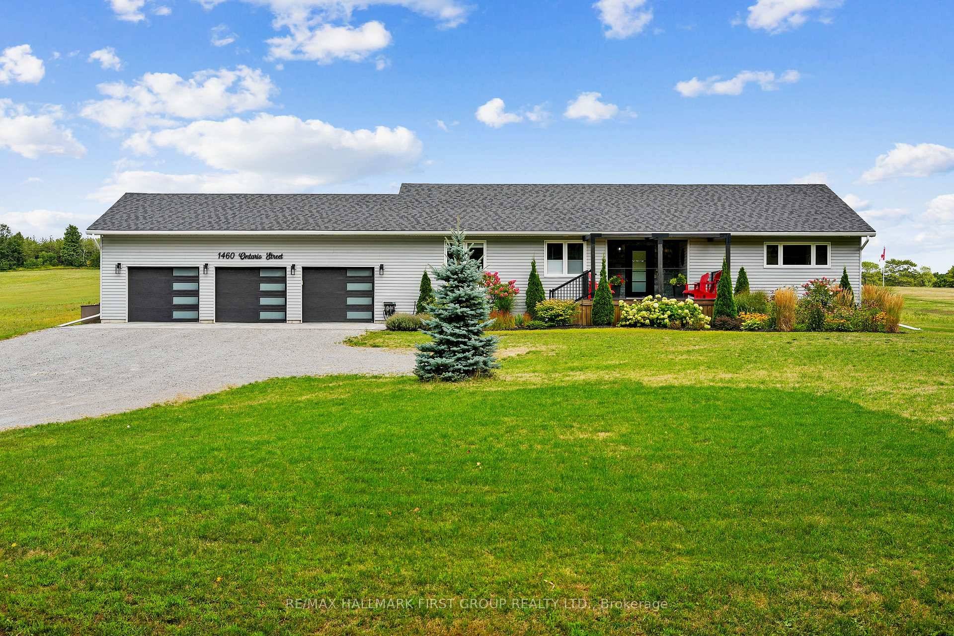 Overflowing with curb appeal, this stunning property showcases a three bay garage, an interlocking driveway area, with a charming walkway through perennial gardens to a front porch framed by incredible ...