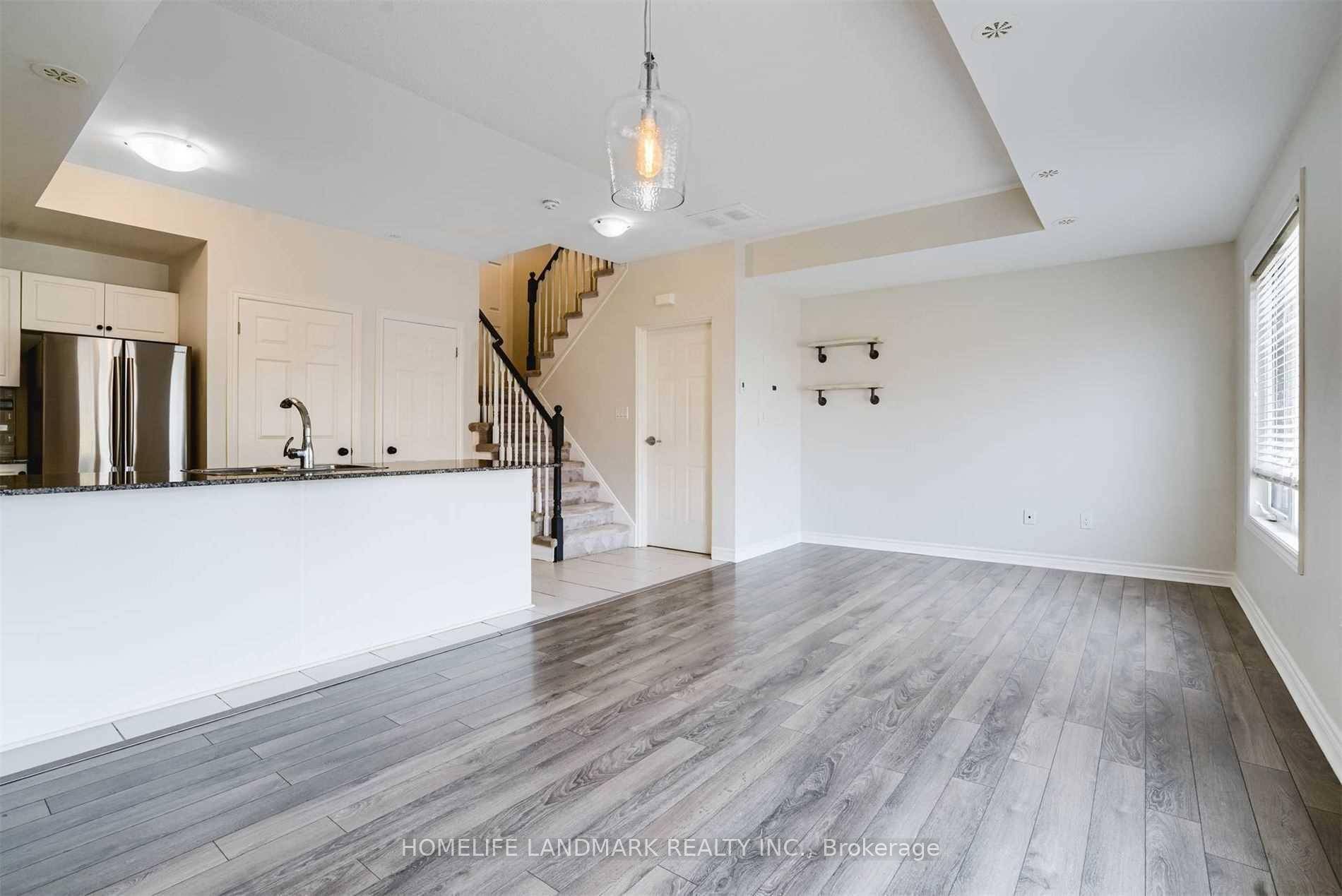 Well maintained 2 Bed, 3 Bath End Unit Stacked Townhome comes with granite counters, custom cabinets, engineered floors, and high end S S appliances.
