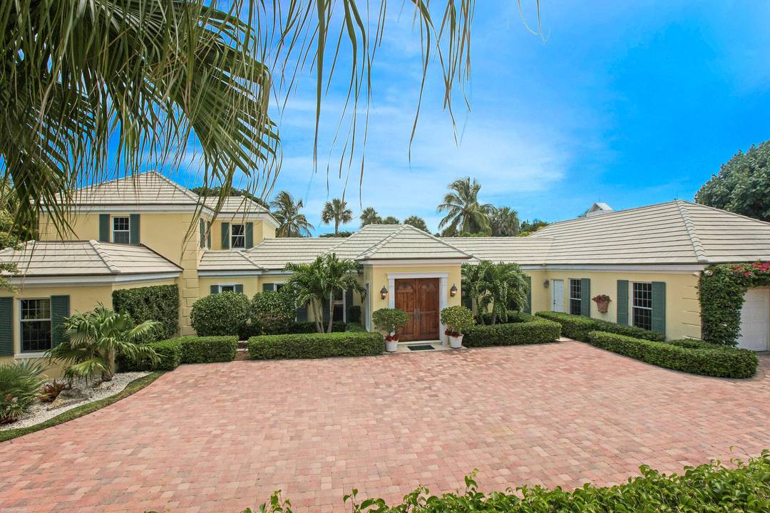 Refined Bermuda style elegance defines this two story Jupiter Island residence, ideally positioned in a coveted central island setting.
