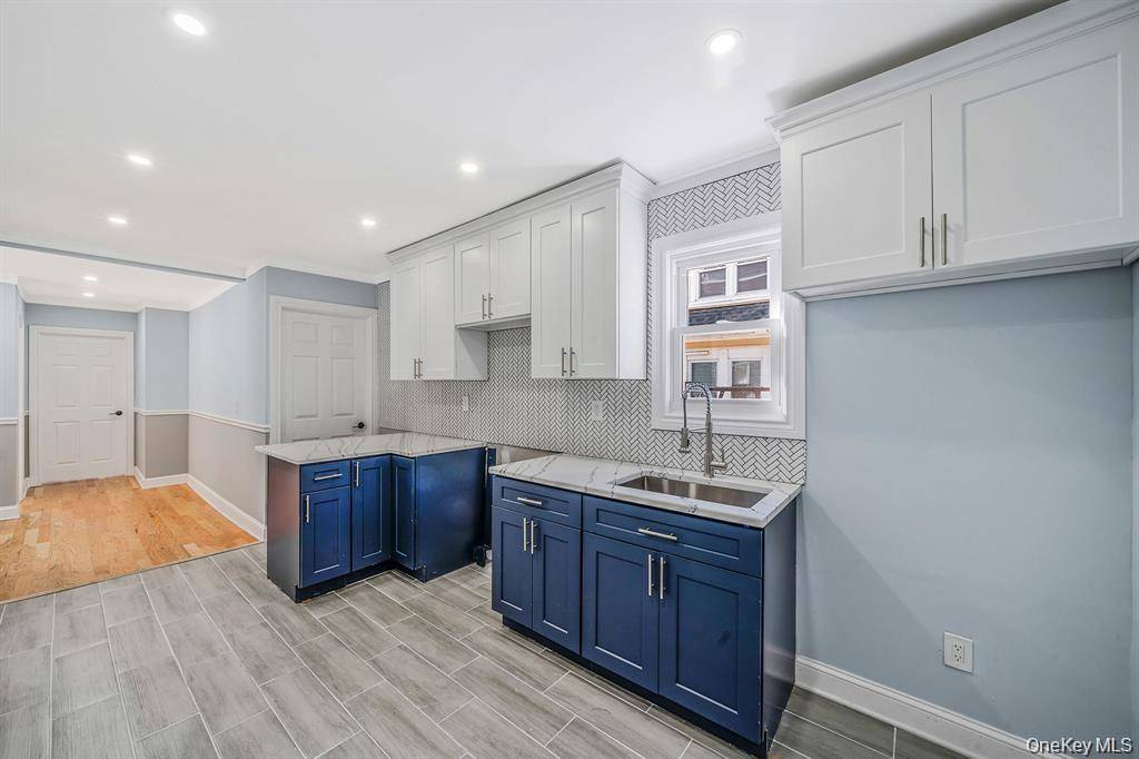 Welcome to a legal two family home that perfectly blends modern living with exceptional investment potential.