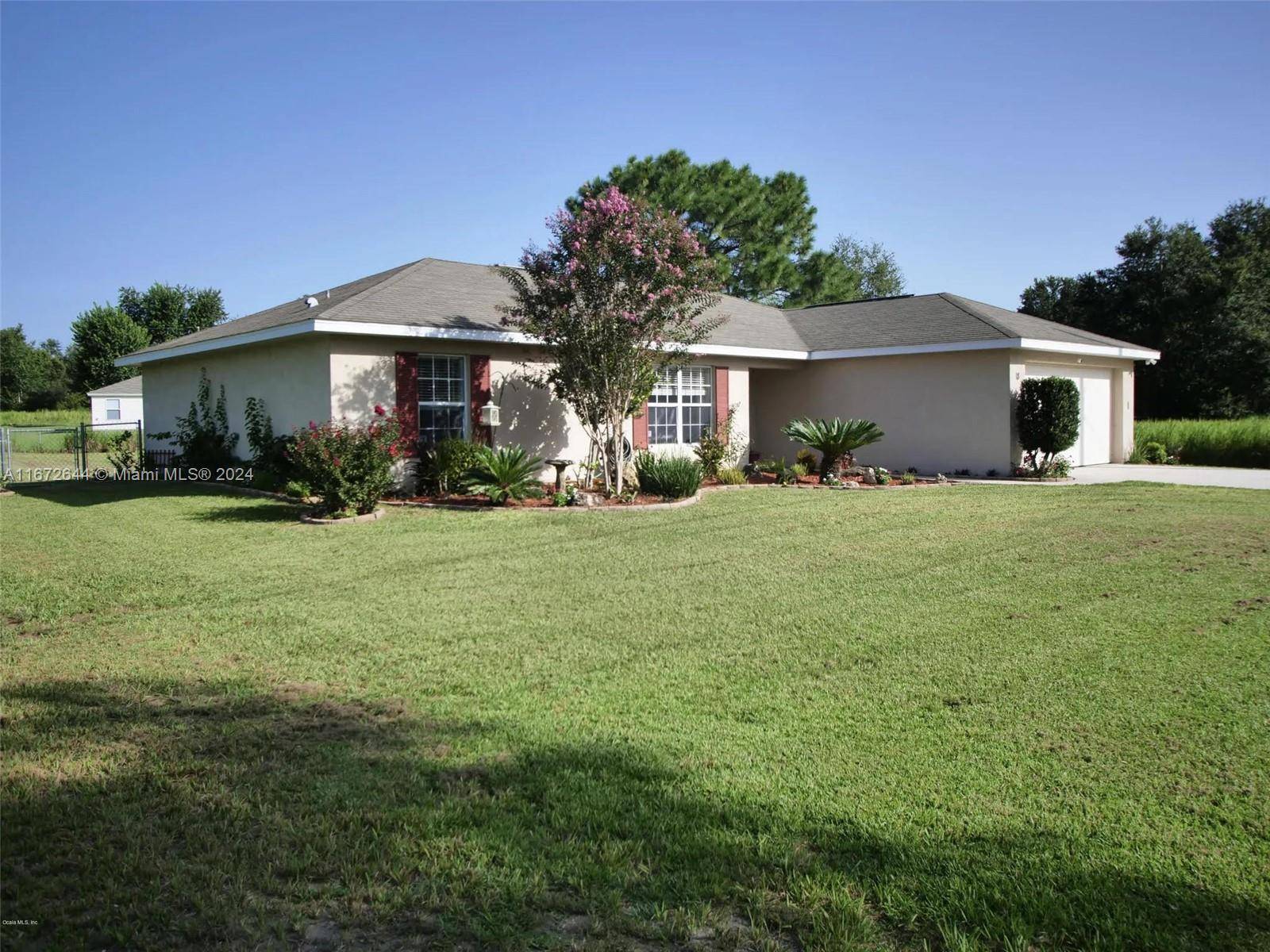 Move in ready home, This spacious three bed two bath home with a two car garage features a split floor plan, vaulted ceilings, tile and laminate flooring throughout.