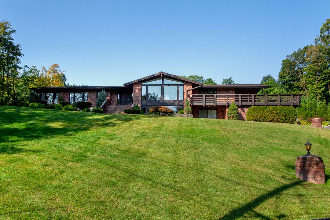 This fabulous contemporary ranch is light filled and ideally situated on an acre lot at the end of a quiet cul de sac !