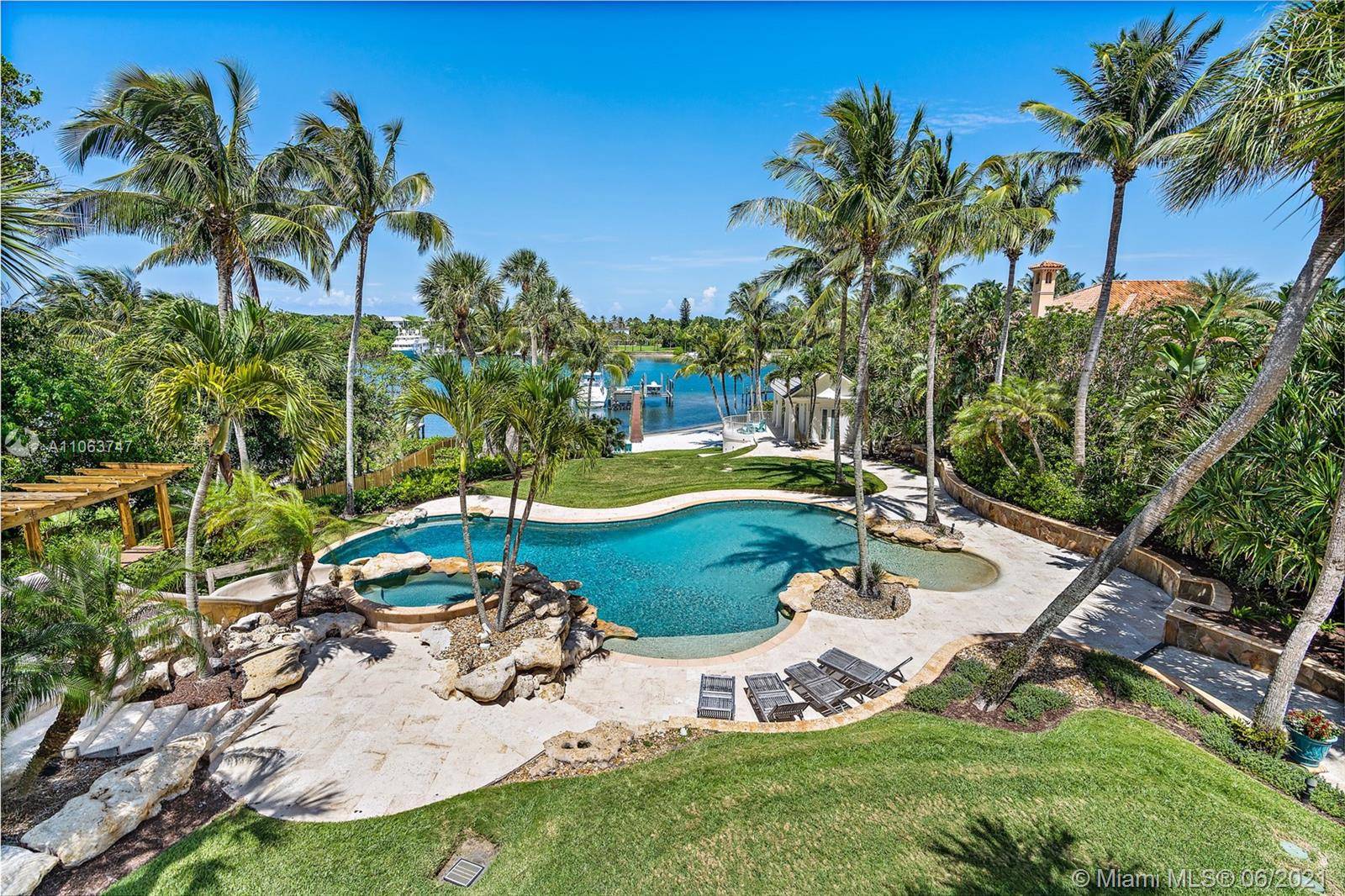 On 100 feet of blue, Intracoastal waters this plantation style estate on 3.
