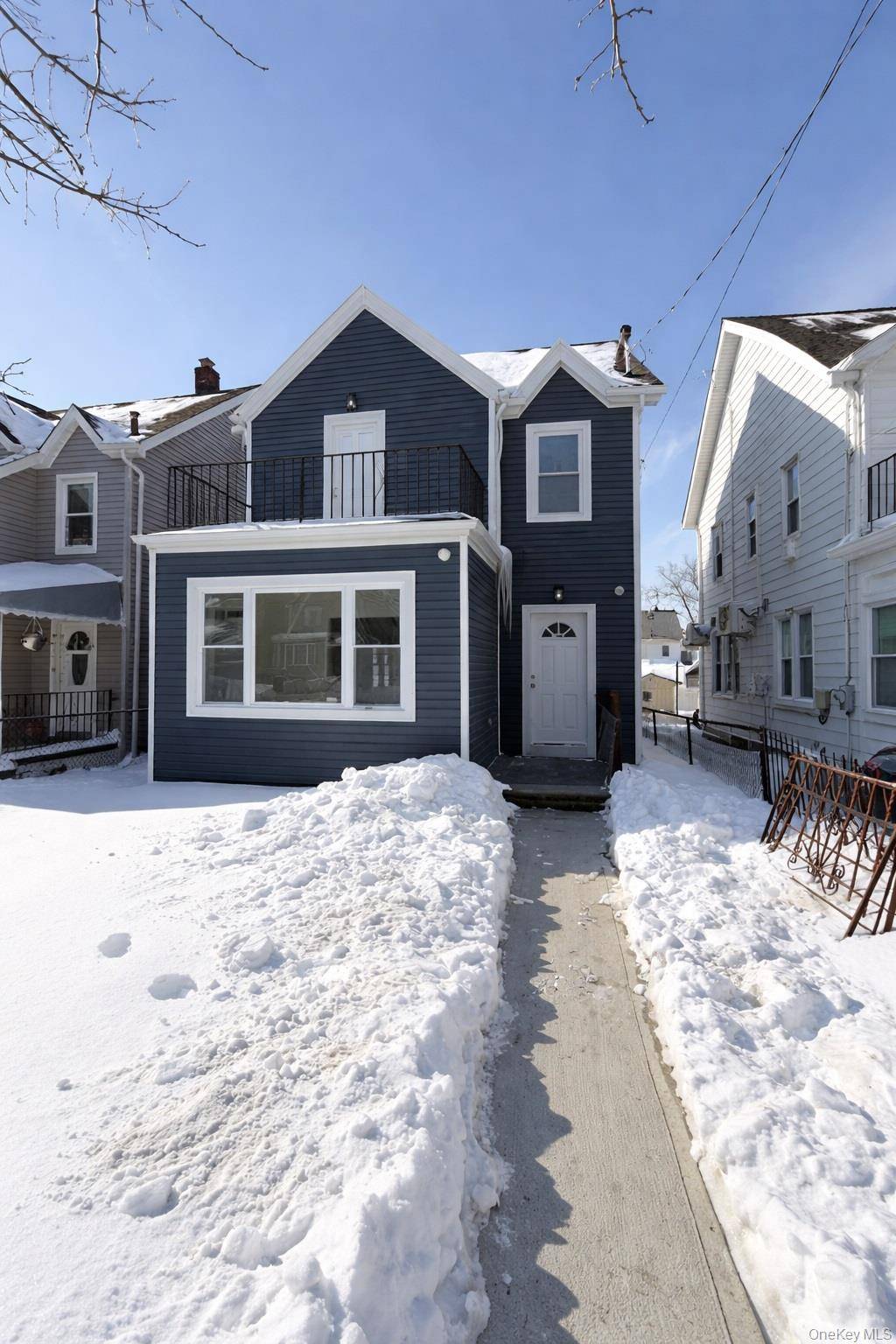 Detached single family home with private driveway and garage on quiet 198th St in Saint Albans.