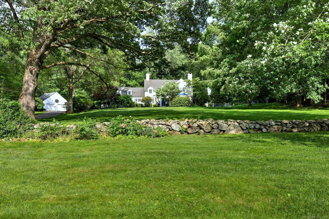 Nestled amidst lush, mature plantings, this stately 4 bedroom Colonial exudes timeless elegance and offers exceptional privacy.