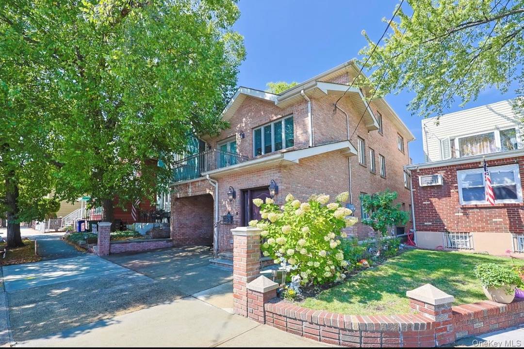 Beautiful, one of a kind 3 story brick home located on the Maspeth Middle Village border is a custom built legal 2 Family fully detached.