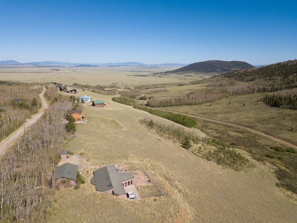 This unique ranch style, earth sheltered berm construction home has views all around is energy efficient w south facing windows to harness the passive solar benefits.