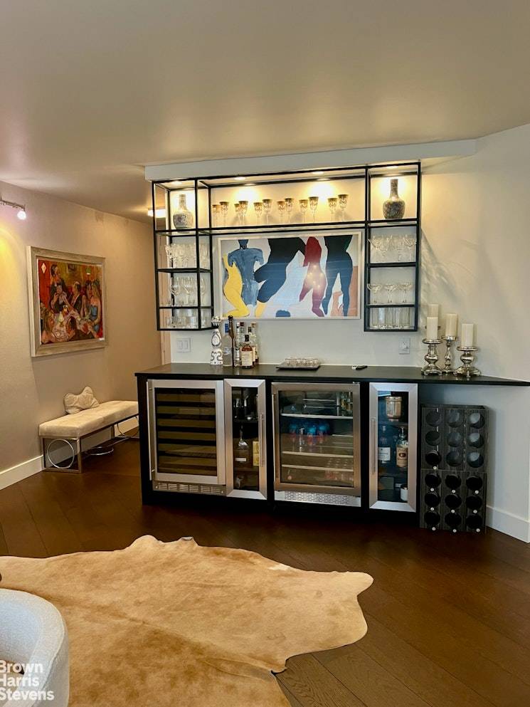 Triple Mint large one bedroom featuring a chef's kitchen with Bertazoni oven with overhead exhaust, Fisher amp ; Paykel refrigerator and Whirlpool dishwasher, beautiful natural wood cabinetry, gorgeous hardwood plank ...