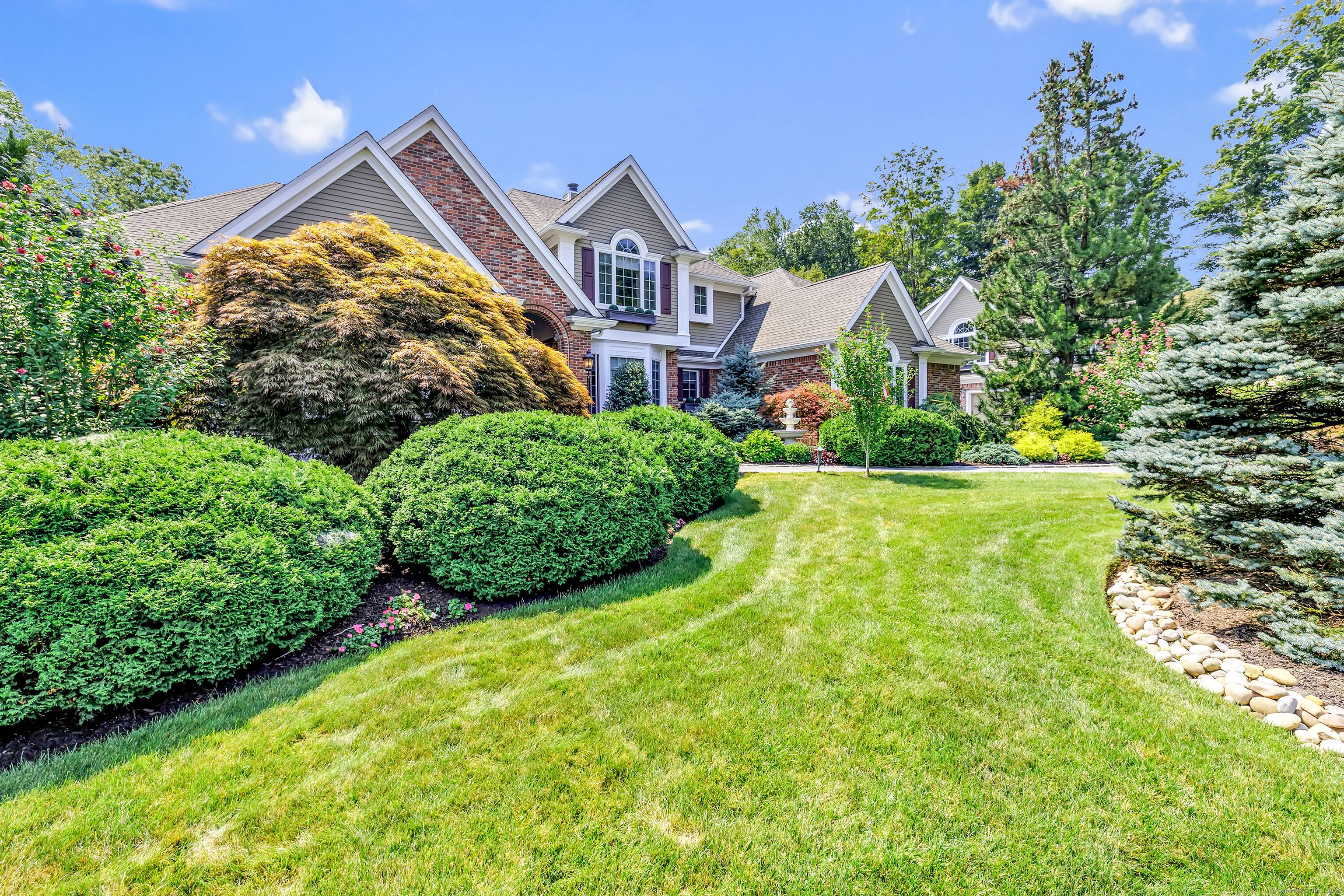 Gated estate on a private cu de sac with 2 driveways, park like grounds and extraordinary Reservoir views all completely fenced in.