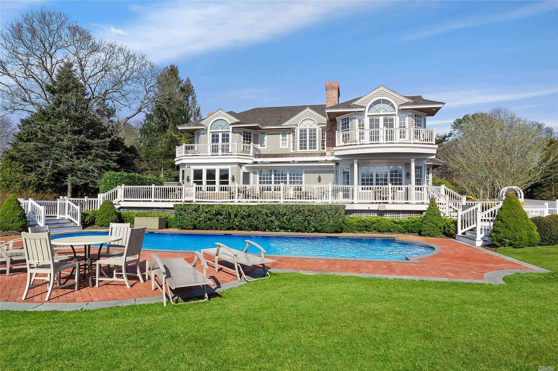Down a private drive, this newly renovated 8 BR, 8.