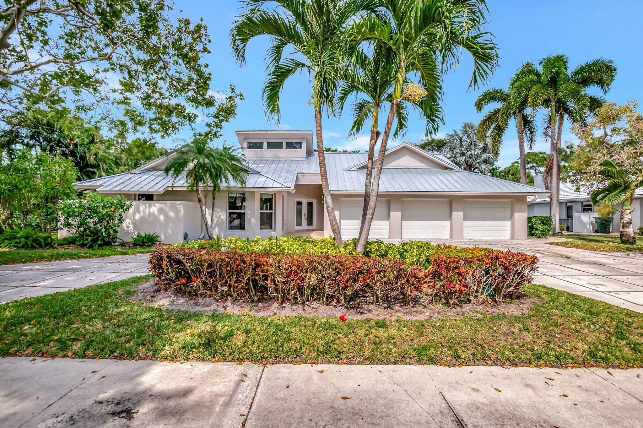 Luxuriously remodeled contemporary home set on over a half acre set within the prestigious gated community of Boca Bath and Tennis.