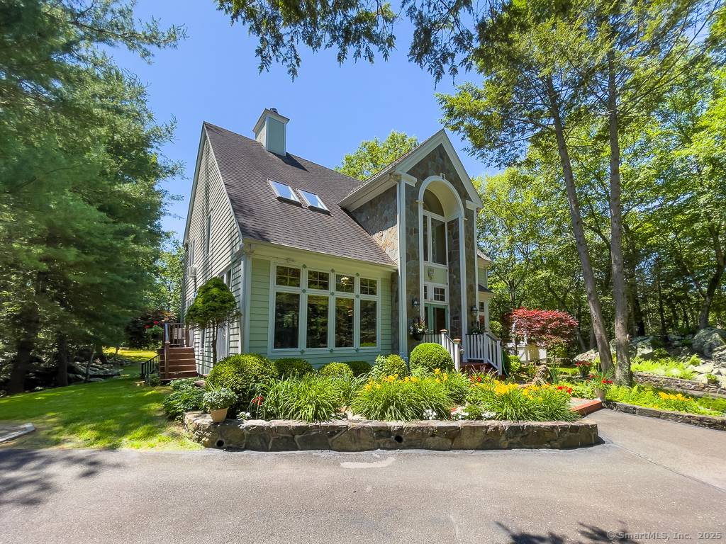 Tucked away on a private, level 2 acre lot near Candlewood Lake and Lake Lillinonah, this custom built Post Beam home offers a perfect blend of rustic charm and modern ...