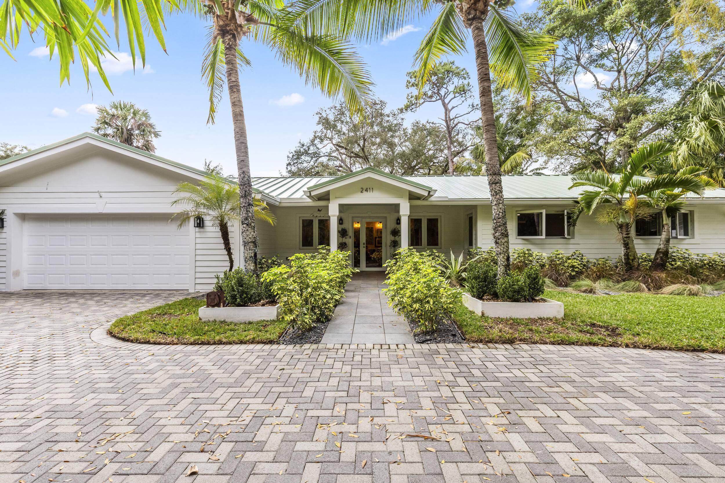 Located in the desirable Riverland Woods neighborhood of Fort Lauderdale with a low HOA, this upgraded home features a new 50 year metal roof and high end finishes.