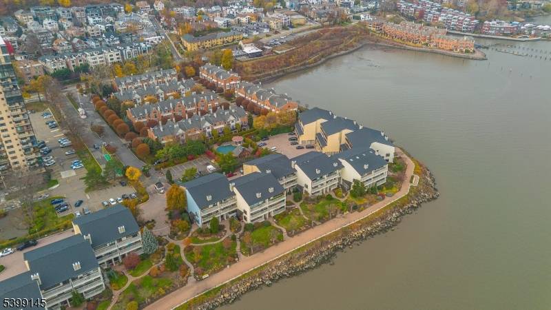 Experience refined waterfront living in this distinctive 3 story townhouse in Edgewater, NJ, once home to the late Kevin P.