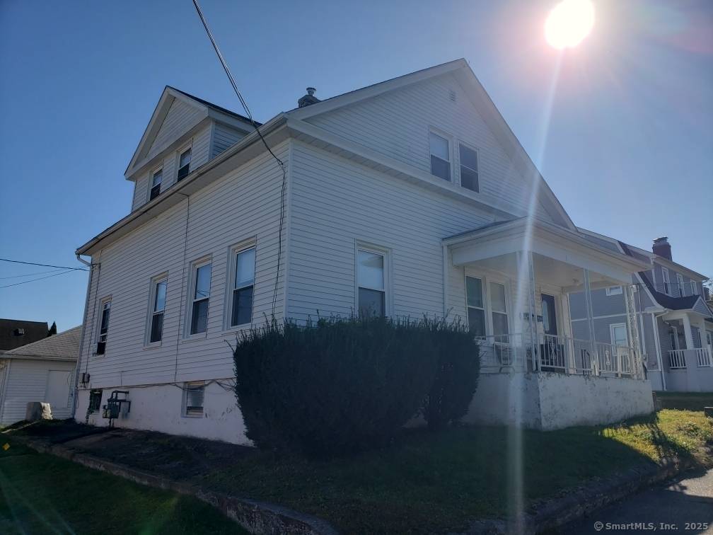 Great Multi Family Home in the heart of Town Plot with 5 detached garages for extra income and two driveways.