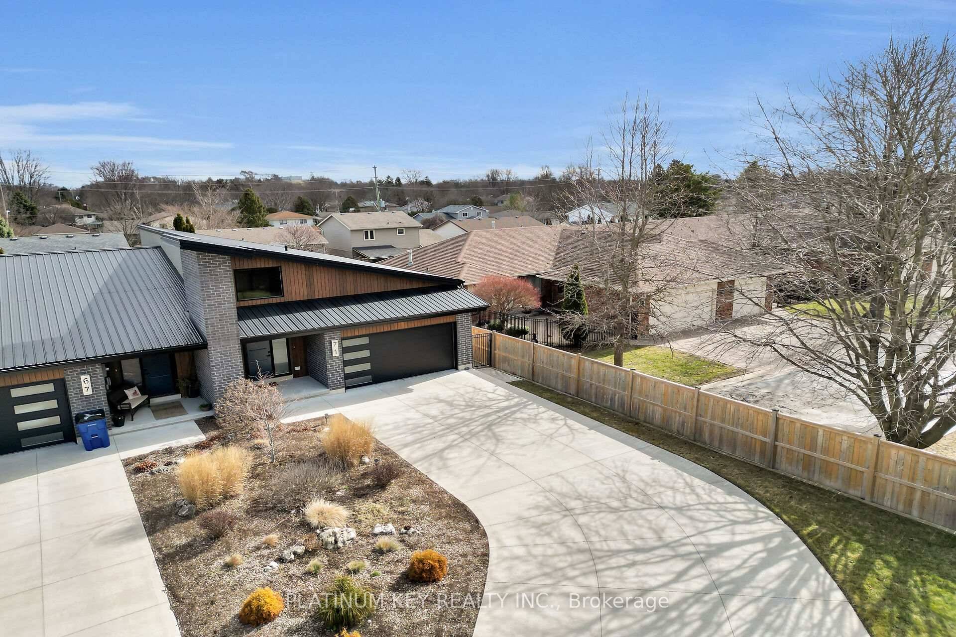 Welcome to this stunning end unit one floor home with an attached 2 car garage equipped with Tesla EV charger.