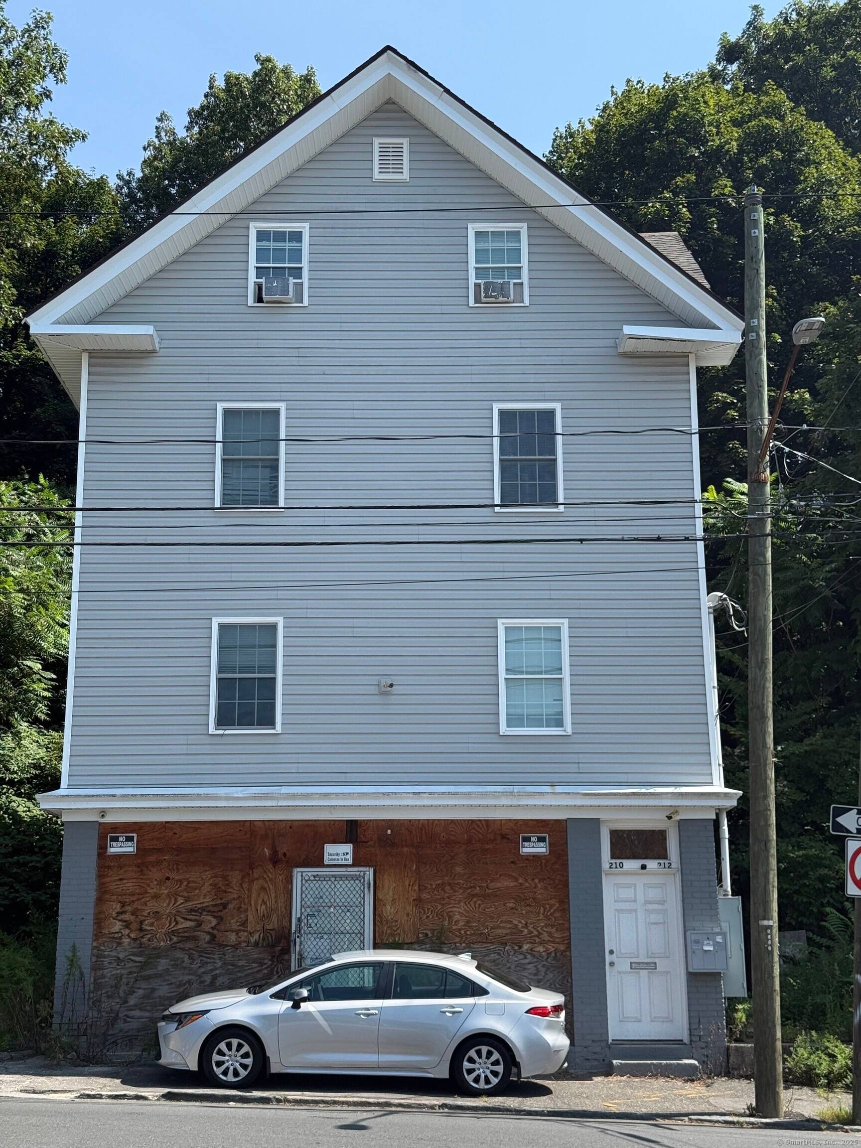 Remodeled three family property with an additional ground level space designated for commercial use located at 210 Bishop Street in Waterbury.