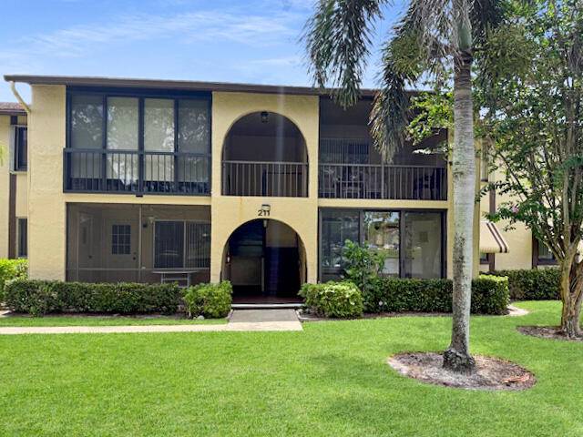 Welcome to this charming 2 bed, 2 bath main level condo with lake view in Greenacres' desirable 55 Pine Ridge South !