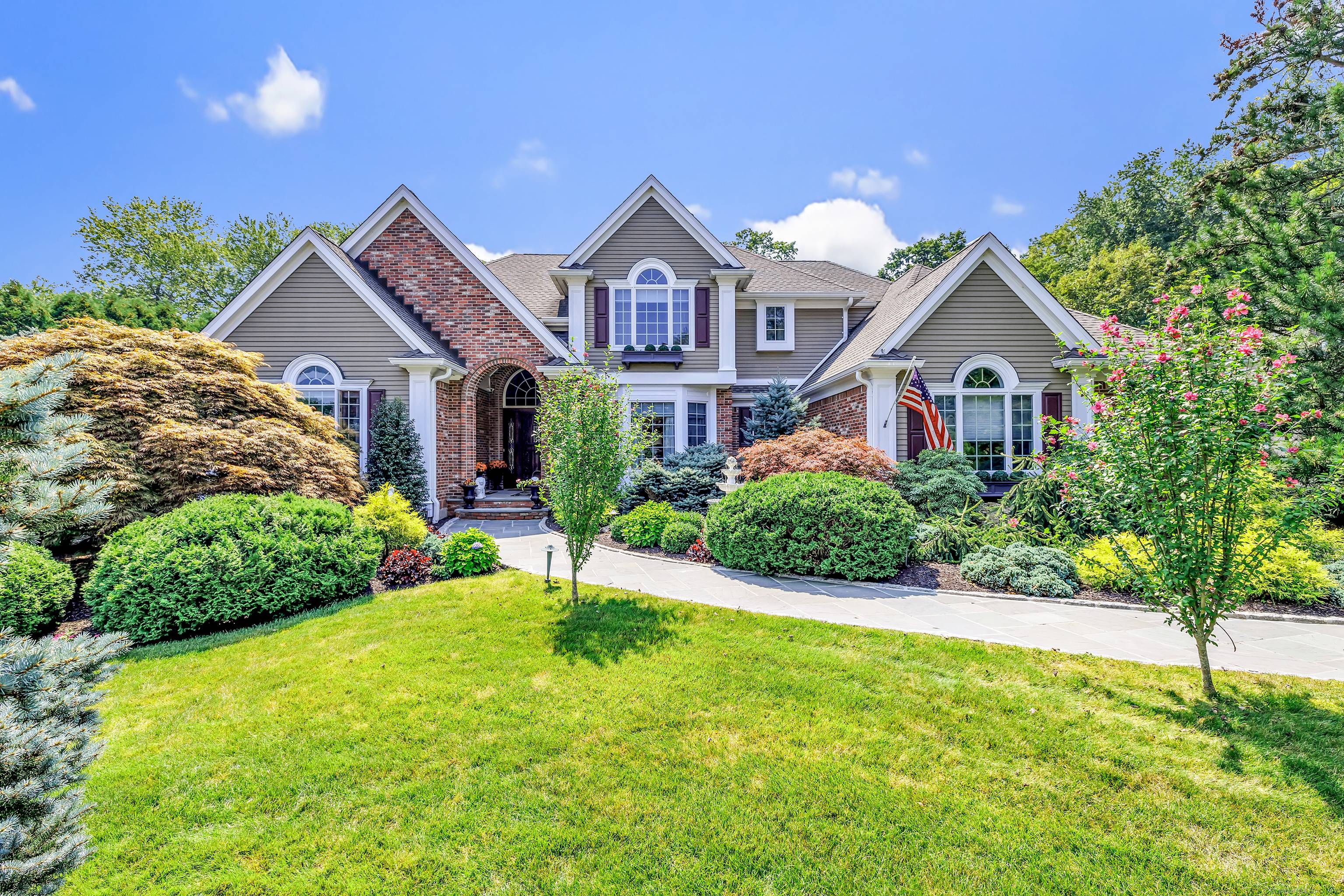 Gated estate on a private cu de sac with 2 driveways, park like grounds and extraordinary Reservoir views all completely fenced in.