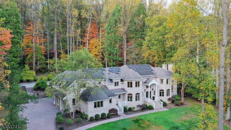 Elegant estate home welcomes you with stately brick pillars, stone walls, and carriage lamps leading to a grand 16 room residence built with perfection in mind.