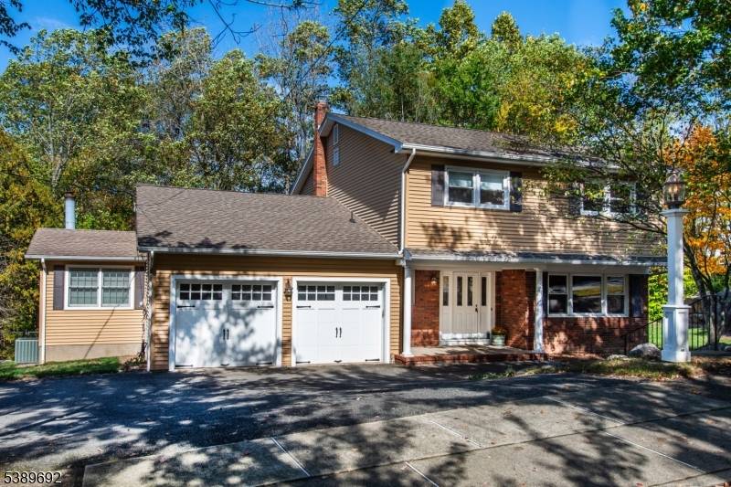 Welcome to this beautifully updated center hall colonial, where timeless elegance meets modern comfort on a quiet cul de sac.