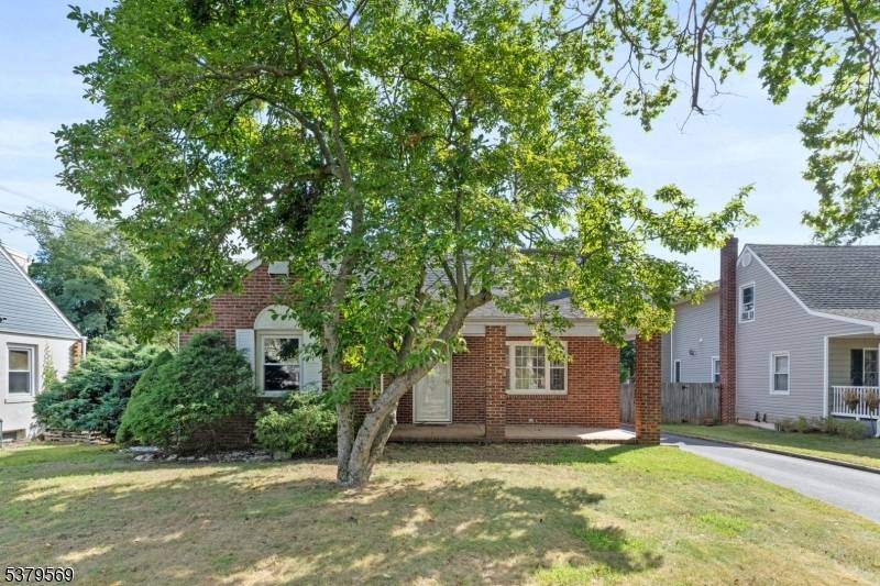 All brick Cape Cod on a large fenced lot with covered porch !