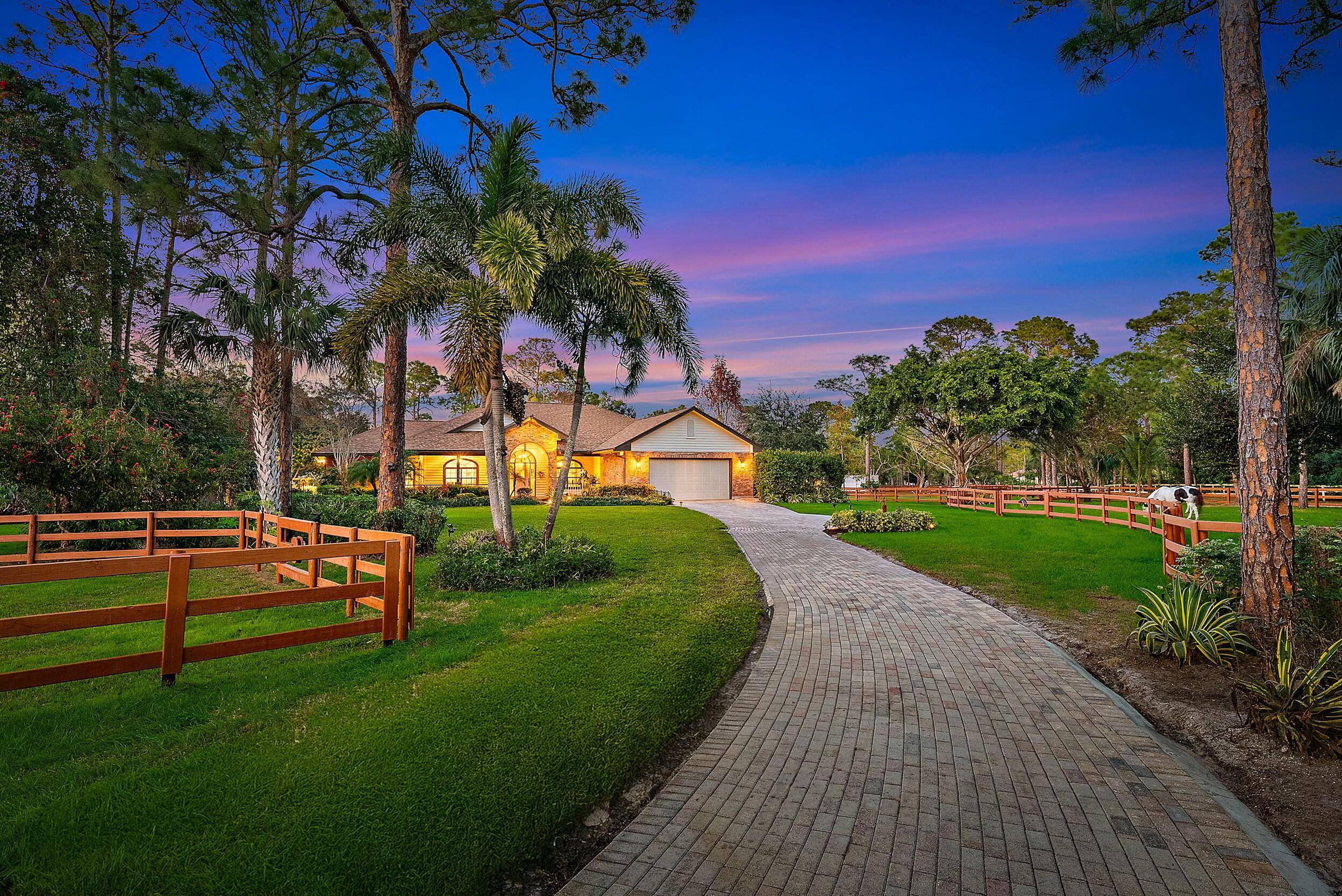 Across the street from a 32 acre equestrian park with arenas, a round pen, and jump courses, this 5 acre property is a dream for horse lovers.