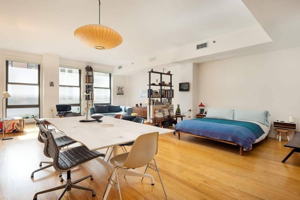 Spectacular Loft with a wall of south facing, floor to ceiling windows in the heart of TriBeCa !