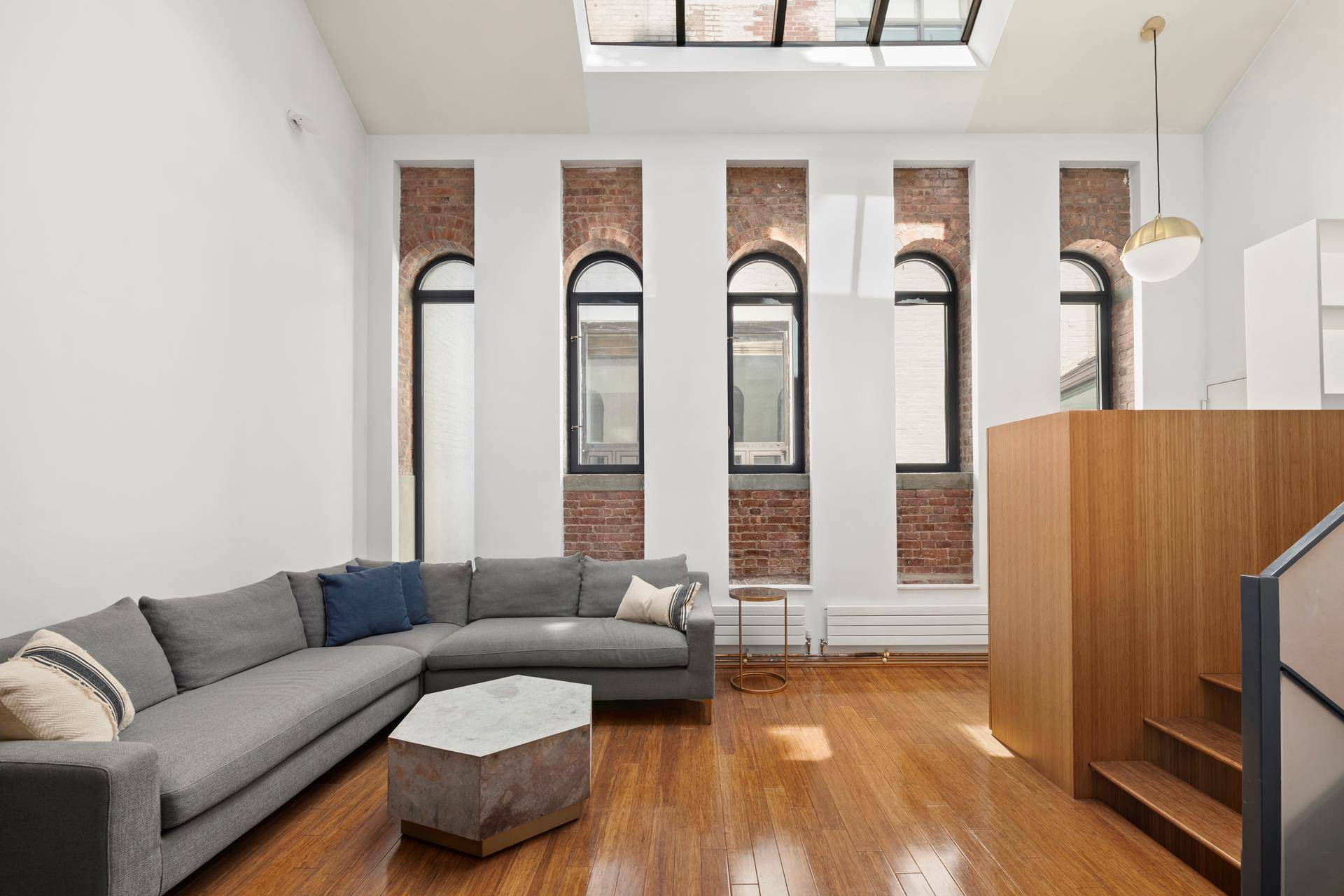 Spanning approximately 1, 350 square feet, this unique triplex loft apartment combines original minimalist and modern touches.