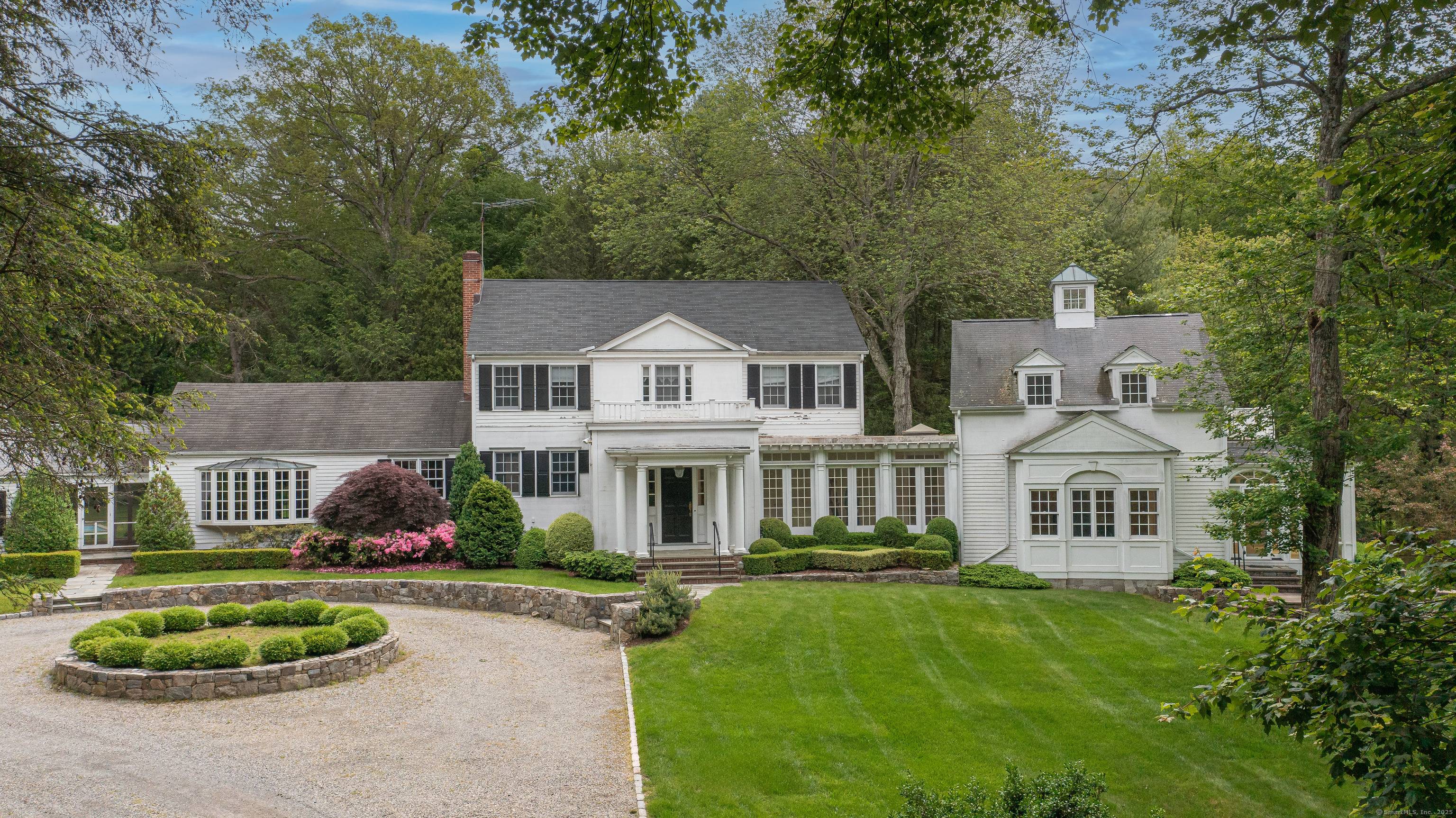Unique opportunity to renovate this classic Westport estate on three professionally landscaped acres with a pool.