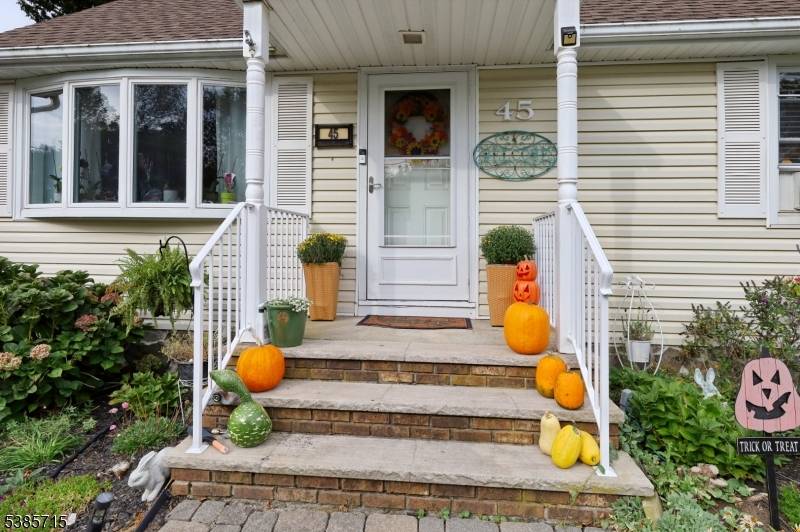 Discover serenity and privacy in this beautifully maintained expanded Cape Cod.