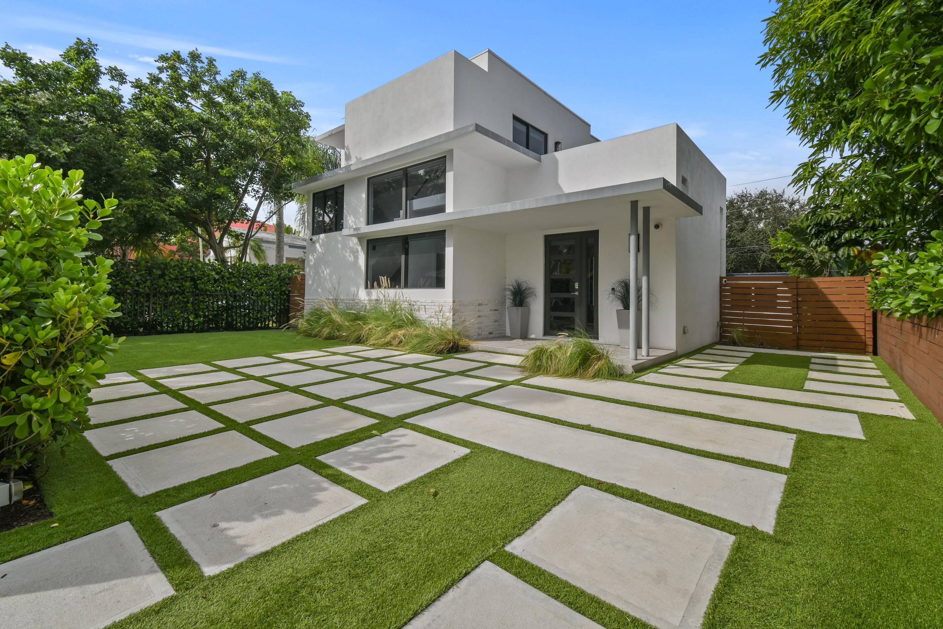 Stunning newer construction, contemporary CBS home with a private guest house sits just two streets from Flagler Drive in the historic Northwood neighborhood.
