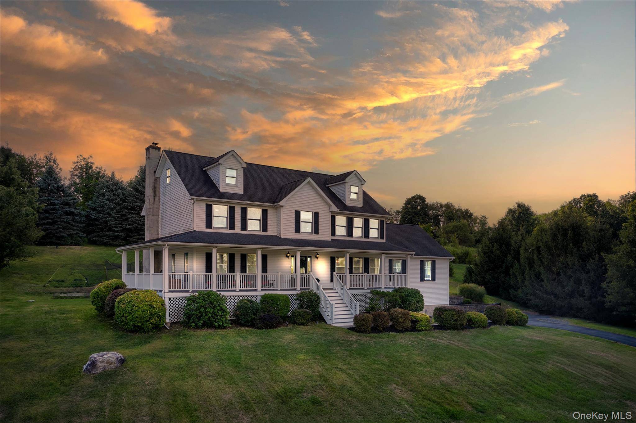 Perched atop a gentle hill with commanding views, this striking home is flooded with natural light and framed by breathtaking sunsets.