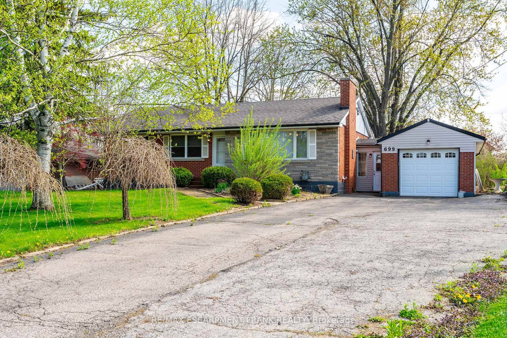 Beautiful Brick Bungalow sitting on a large, private country lot an impressive 75 ft by 271 ft.
