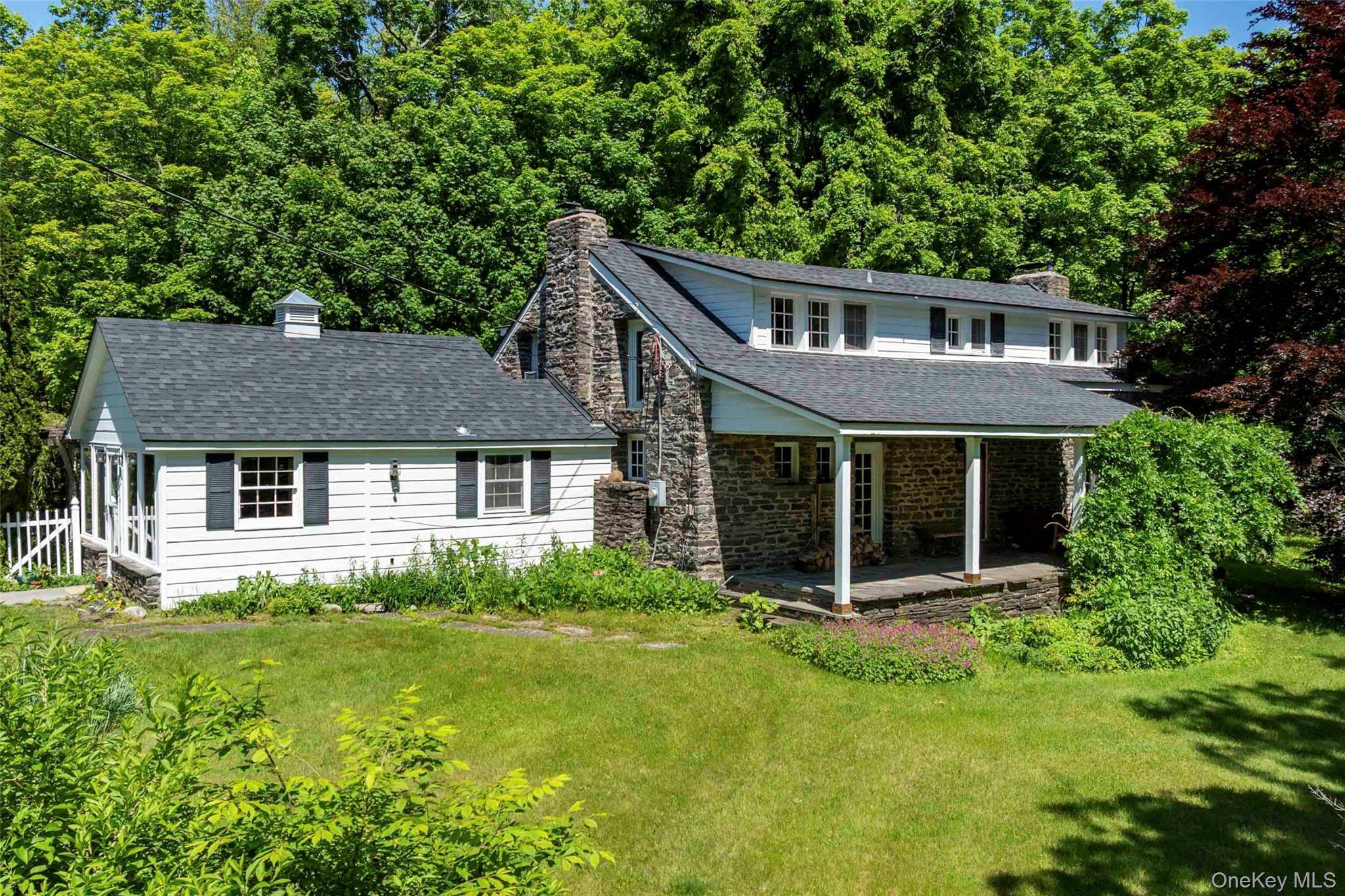 Step back in time with this enchanting antique farmhouse nestled on a sprawling 10 acre semi rural retreat.